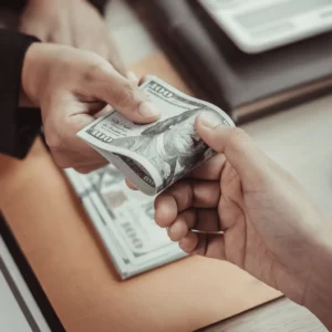 a person handing over a money